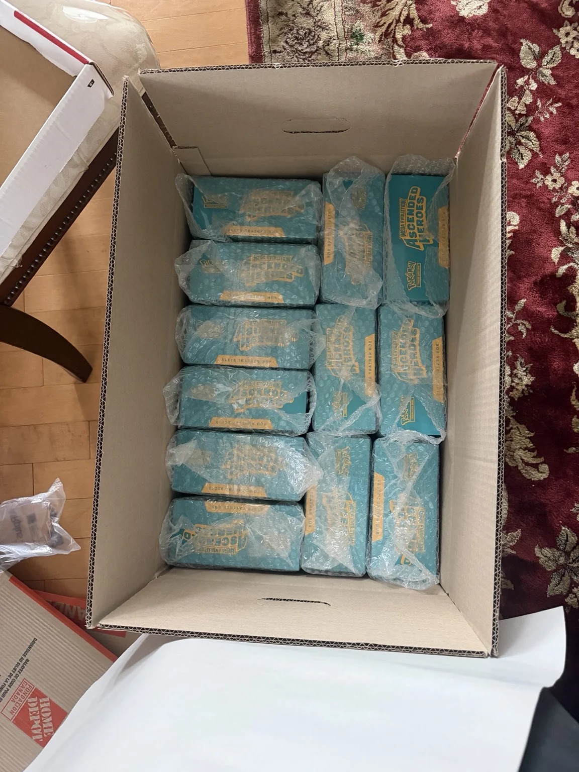 Bubble-wrapped Pokémon Ascended Heroes products protected inside an open shipping carton