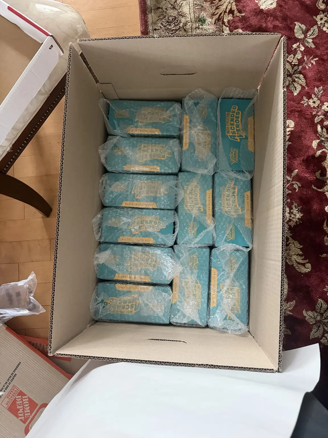 Bubble-wrapped Ascended Heroes Elite Trainer Boxes packed inside a shipping carton