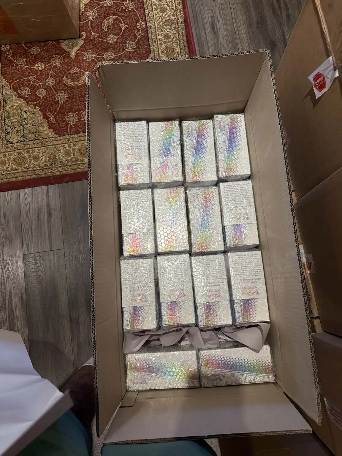Bubble-wrapped sealed Pokémon products arranged inside an open shipping carton