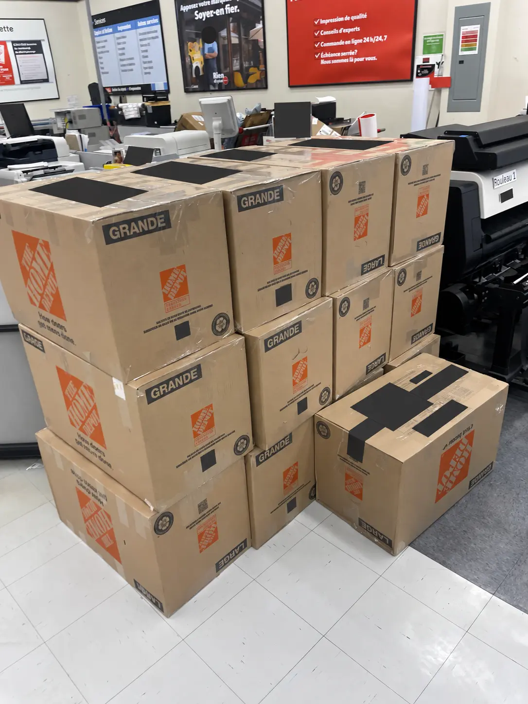 Packed cartons prepared at a carrier counter, with faces and shipping labels concealed