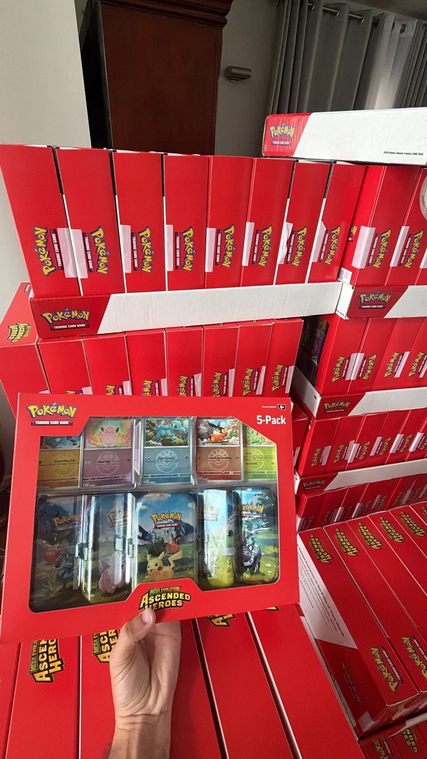 Sealed Pokémon Ascended Heroes 5-Pack products stacked in bulk during KNDT product handling