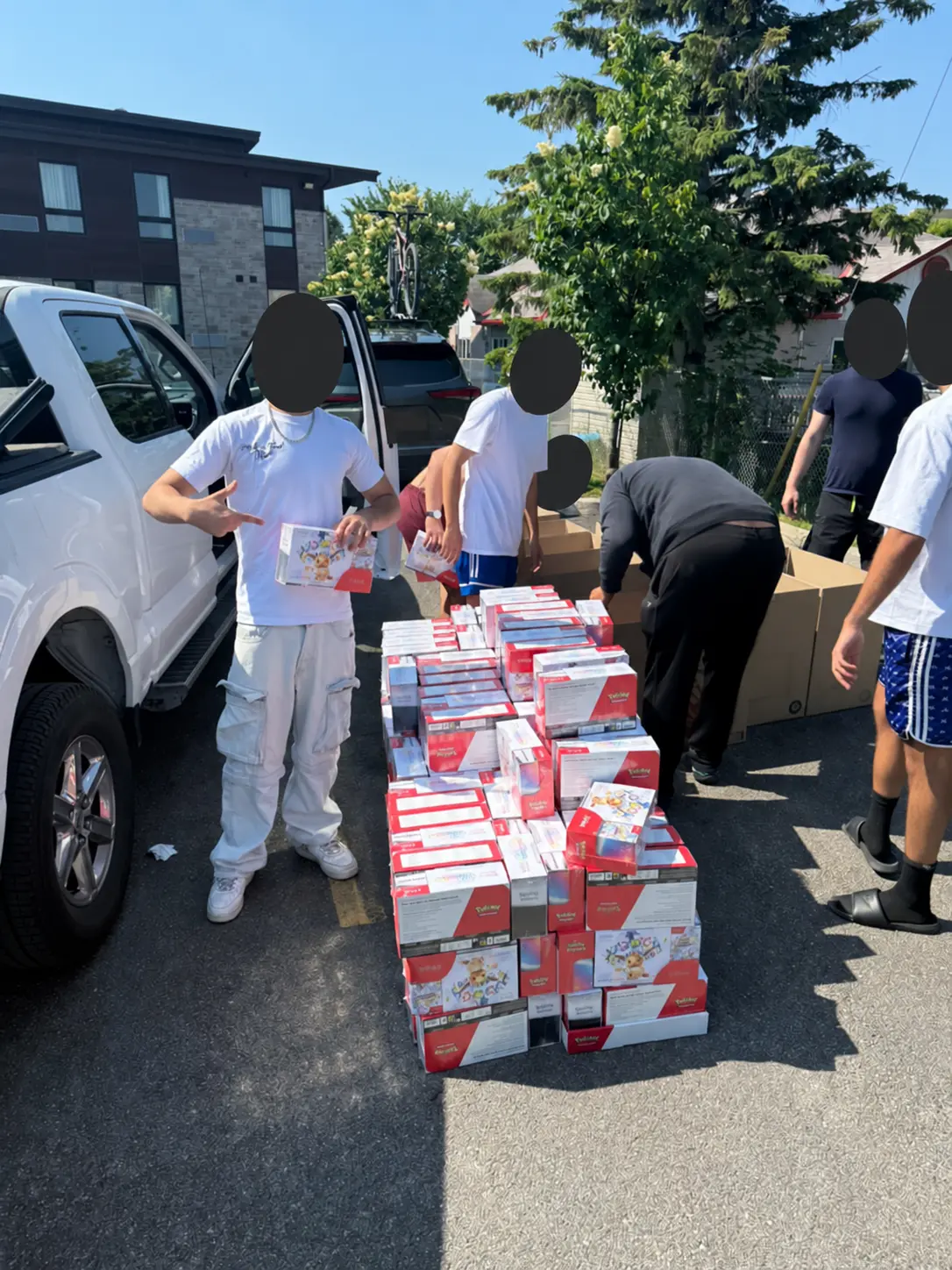 Wholesale Pokémon products organized beside vehicles, with all visible faces concealed