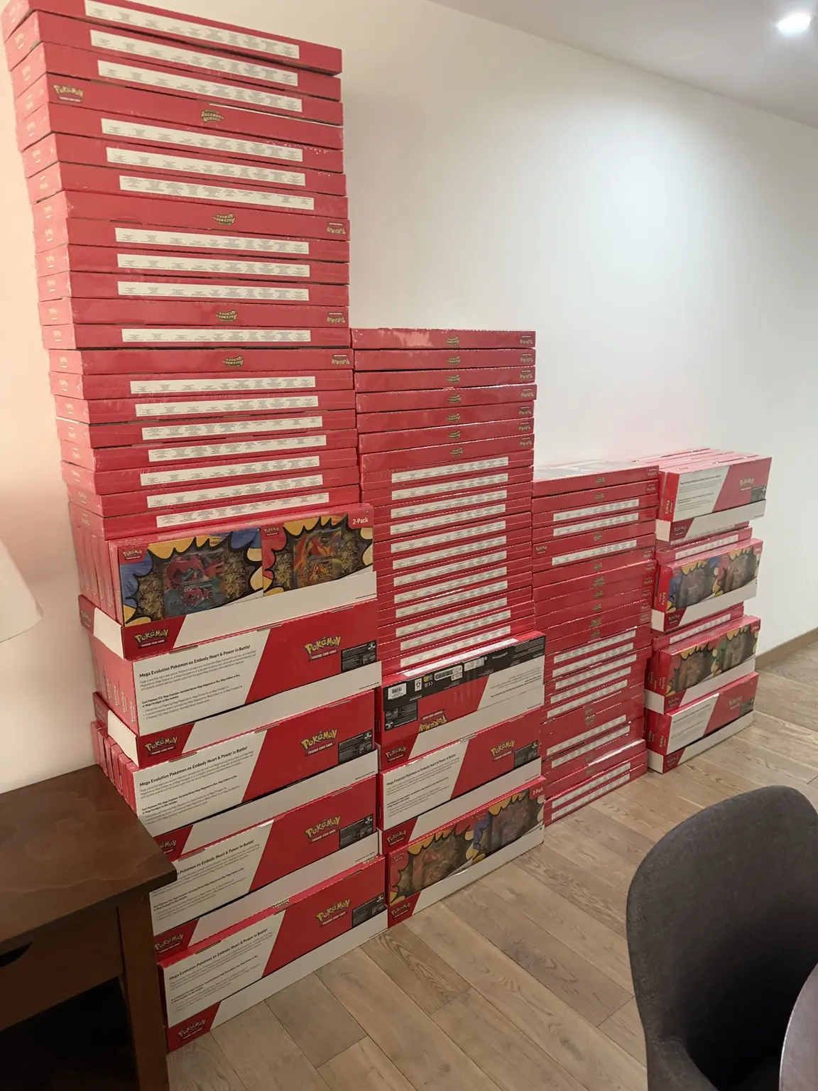 Stacks of sealed Pokémon collection boxes organized indoors